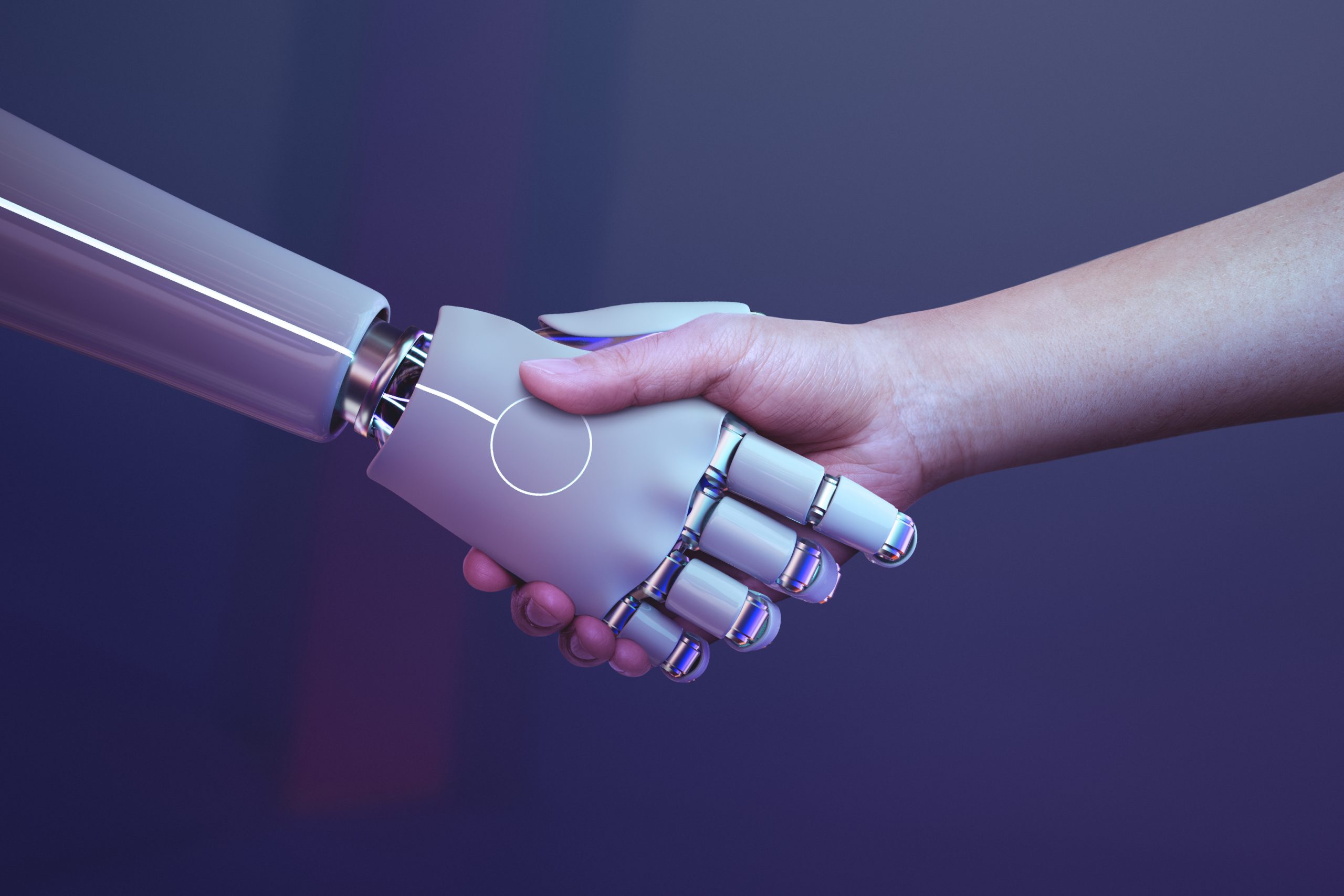 Mano de robot dándole la mano a un humano.